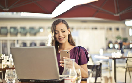 Woman working on her laptop in café