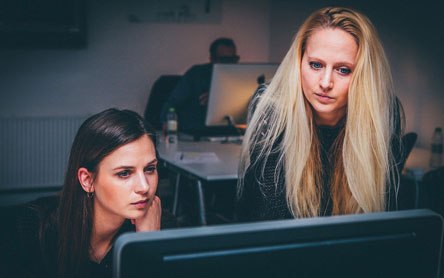 Two women marketers looking at a computer screen