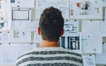 Man looking at different marketing strategies